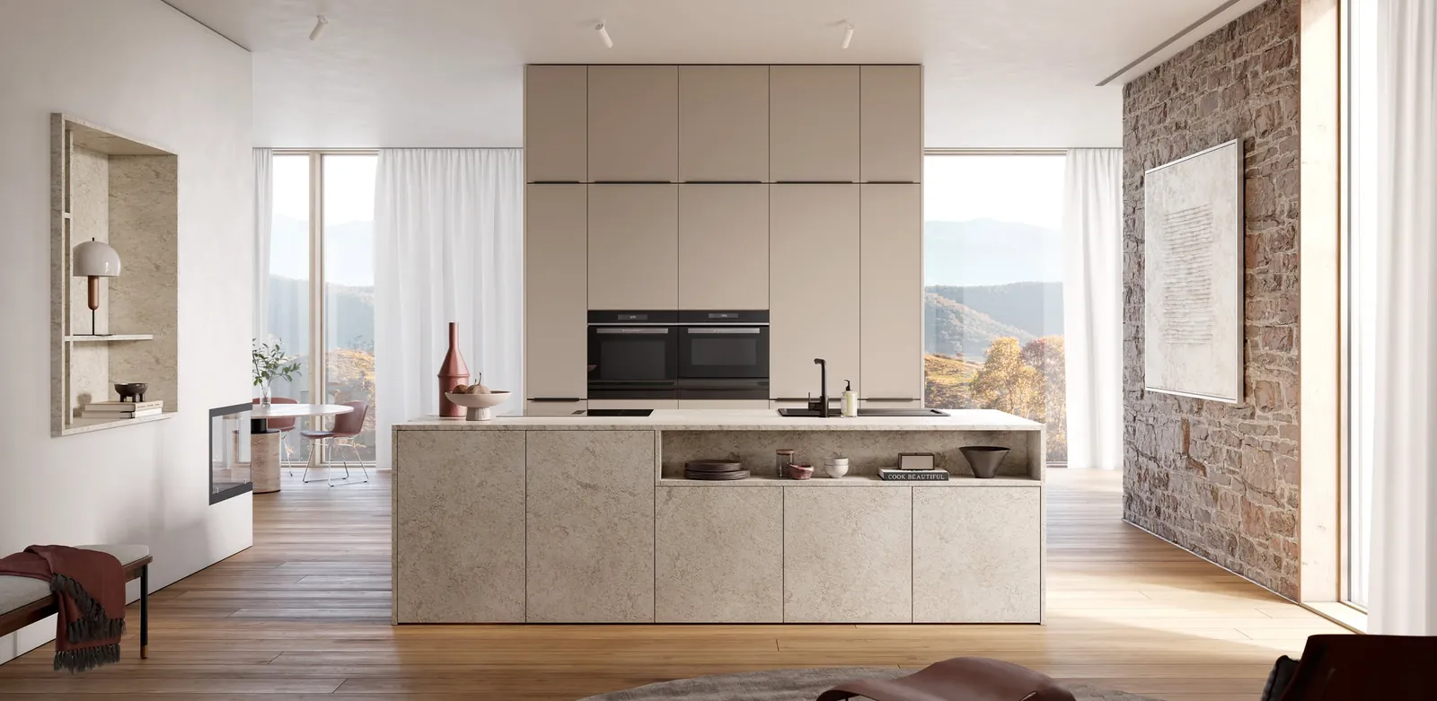 A cashmere kitchen island beside an exposed brick wall